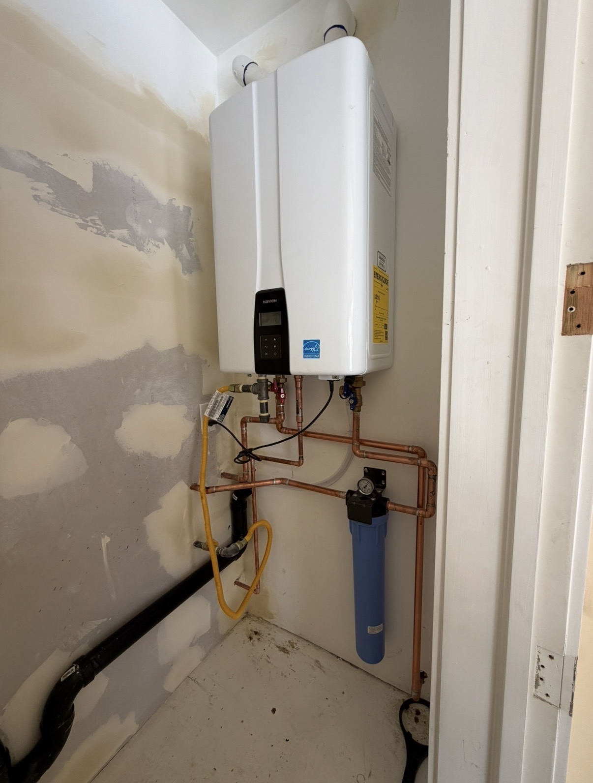 Installed tankless water heater, water filter, and copper plumbing