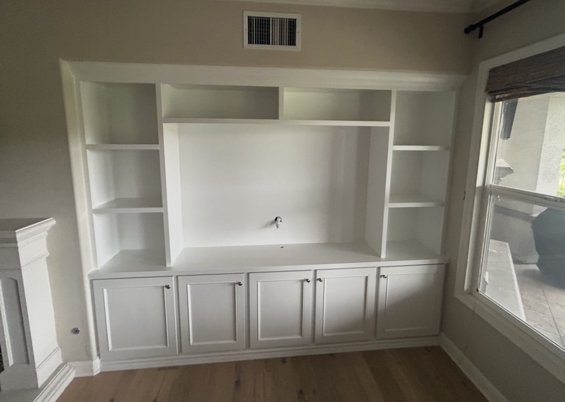 Custom white built-in media cabinet with shelving and storage